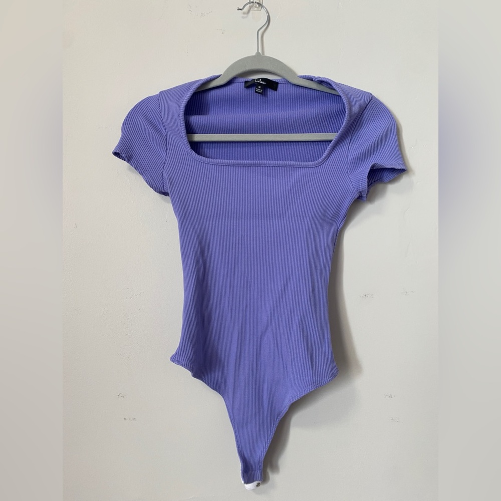 Lavender short sleeved, square neck bodysuit with rubbed fabric